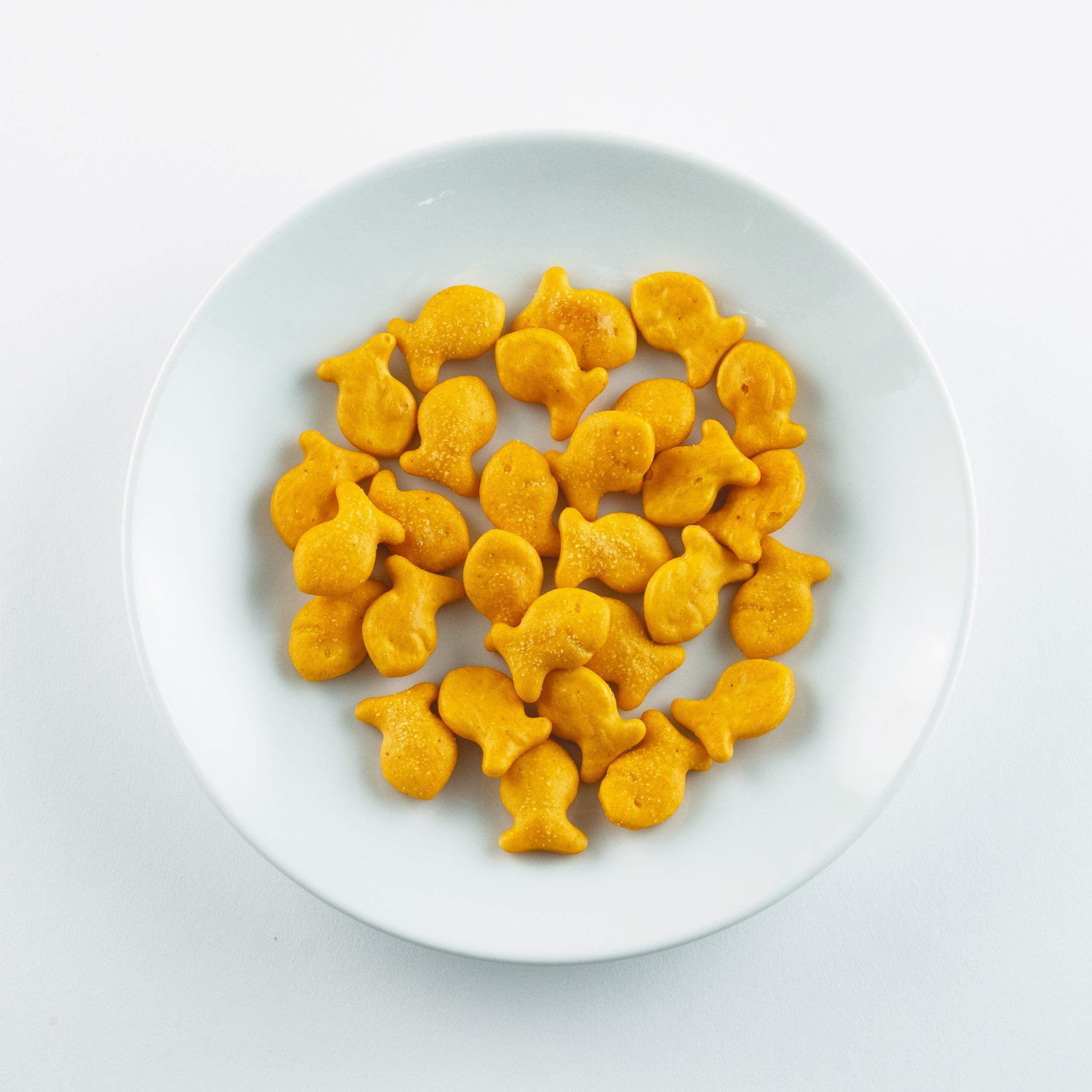 Goldfish pouch beside a soda can for scale, Goldfish portion-sized convenience