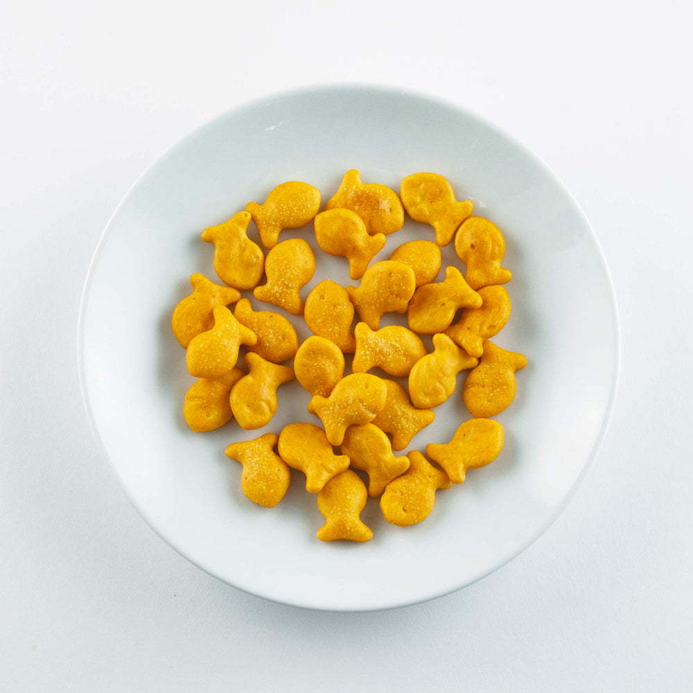 Goldfish pouch beside a soda can for scale, Goldfish portion-sized convenience