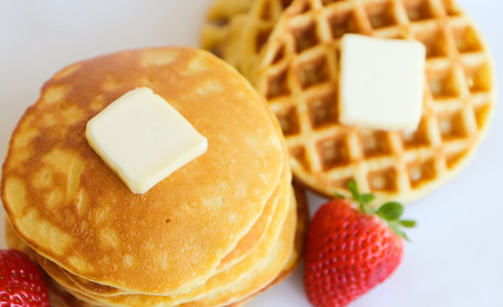 Golden waffles from Good Dee’s Waffle Mix on a plate, sugar-free delight