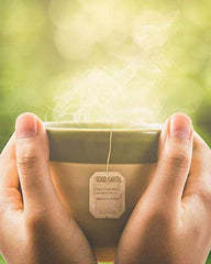Green tea with matcha and citrus infusion steeping in a teacup