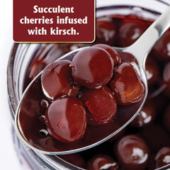 Gourmanity brandied cherries Kirsch bottle and glass capture elegant presentation.