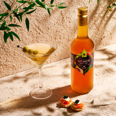 Gourmanity olive brine dirty martini glass highlights bar-quality flavor ready at home.