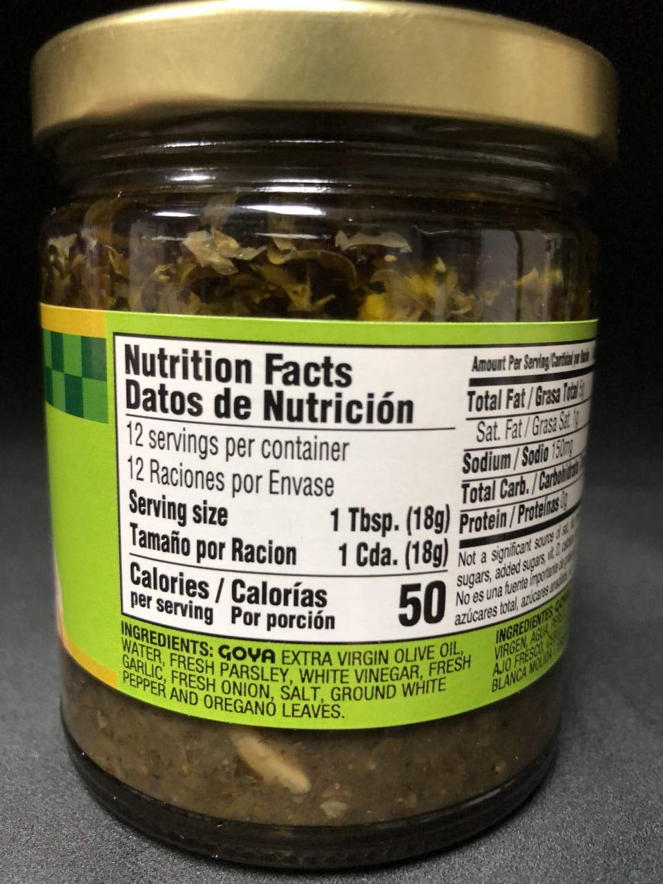 Close-up of fresh herbs in Goya Chimichurri with olive oil sheen.