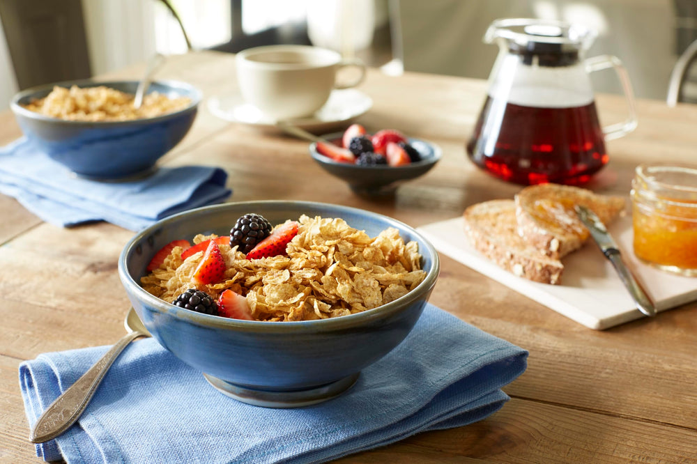 Grape-Nuts Flakes pouring into milk to illustrate quick morning meal.