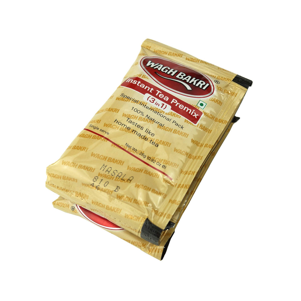 Milk solids and sugar sachets beside Great Bazaar tea for ready flavor