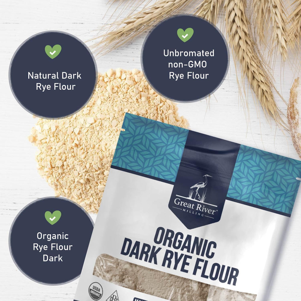 Great River Milling Organic Dark Rye Flour with rye bread slice on wooden board.