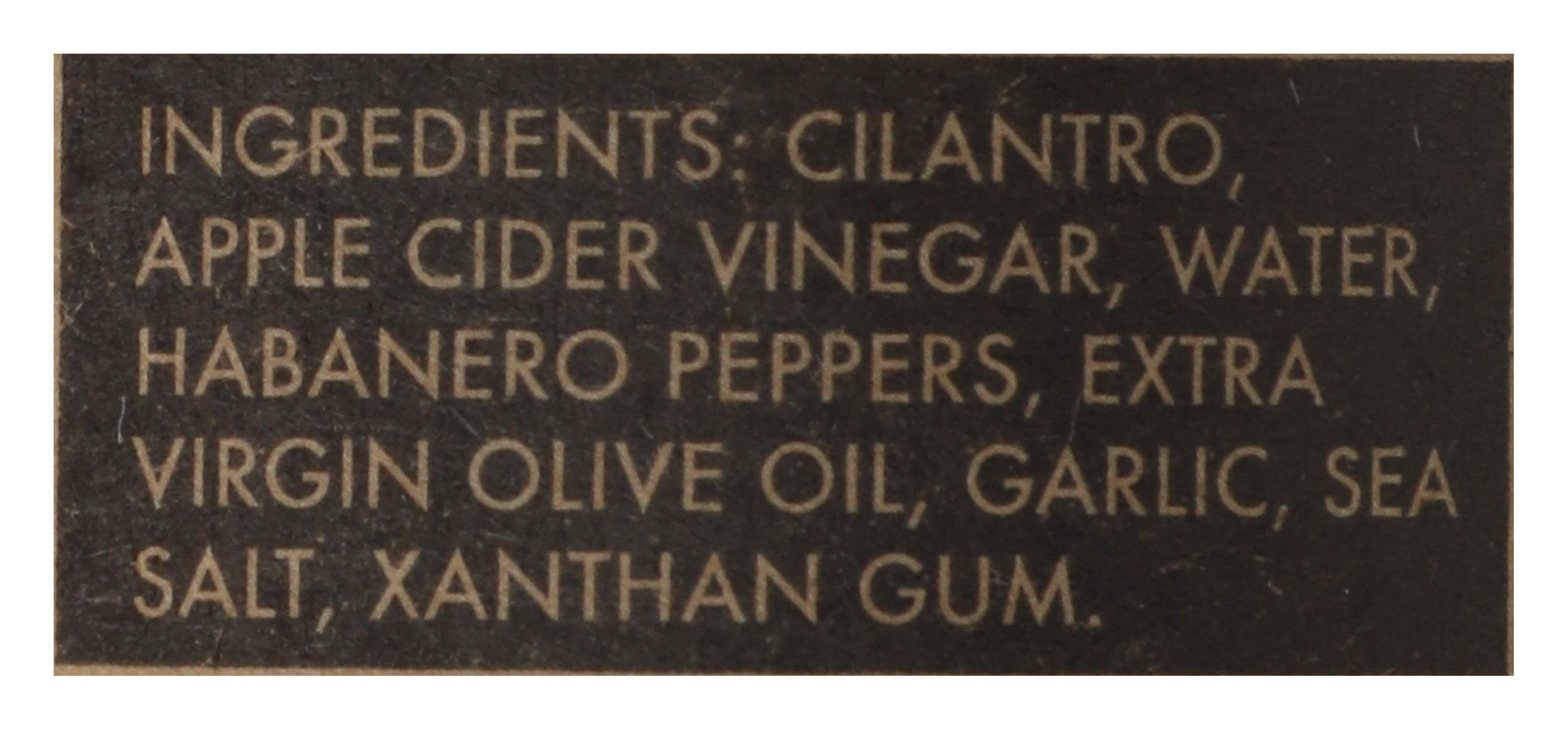Closeup of cilantro and garlic in Green Belly Hot Sauce adds fresh flavor
