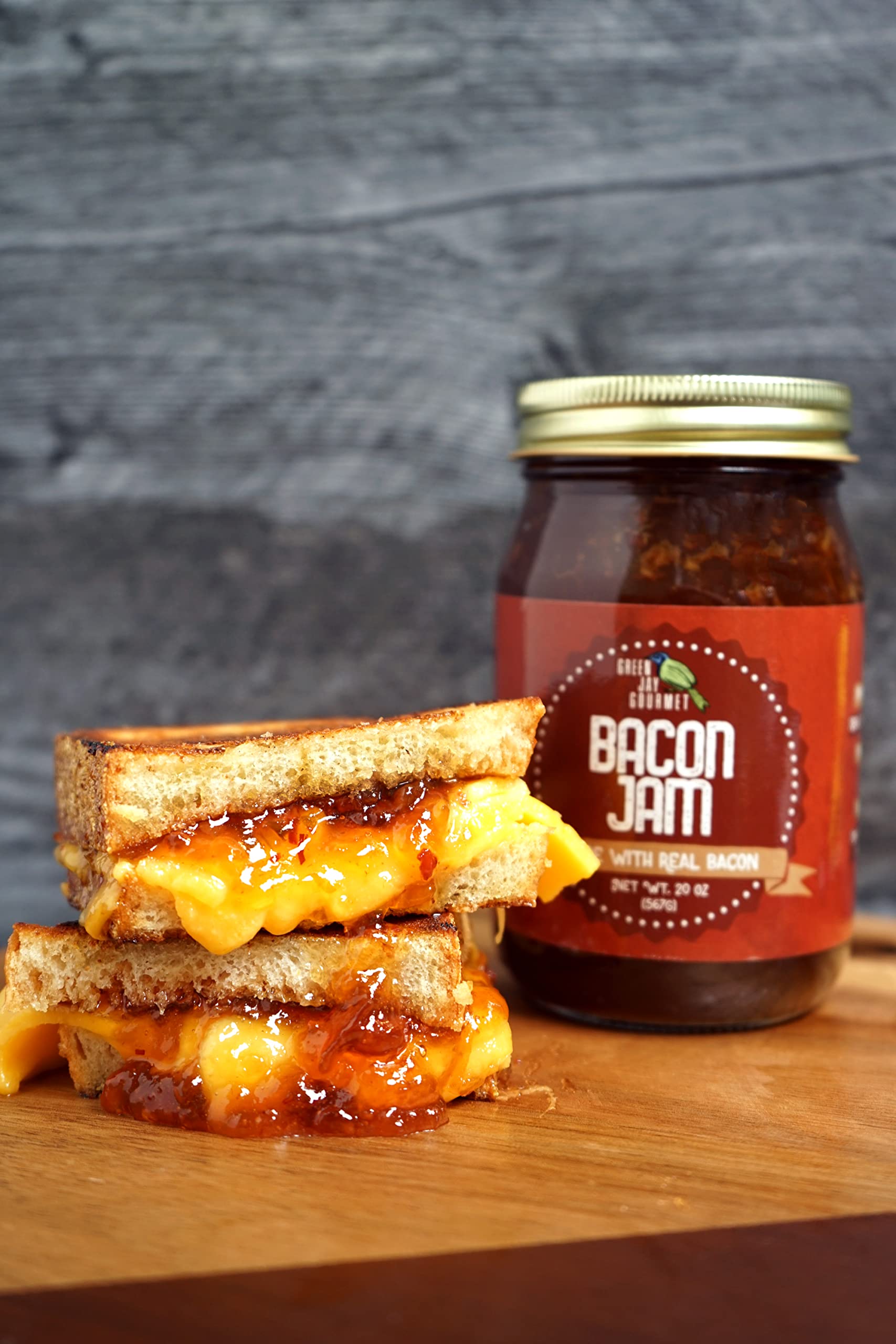 Green Jay Gourmet Bacon Jam on a charcuterie board with cheeses
