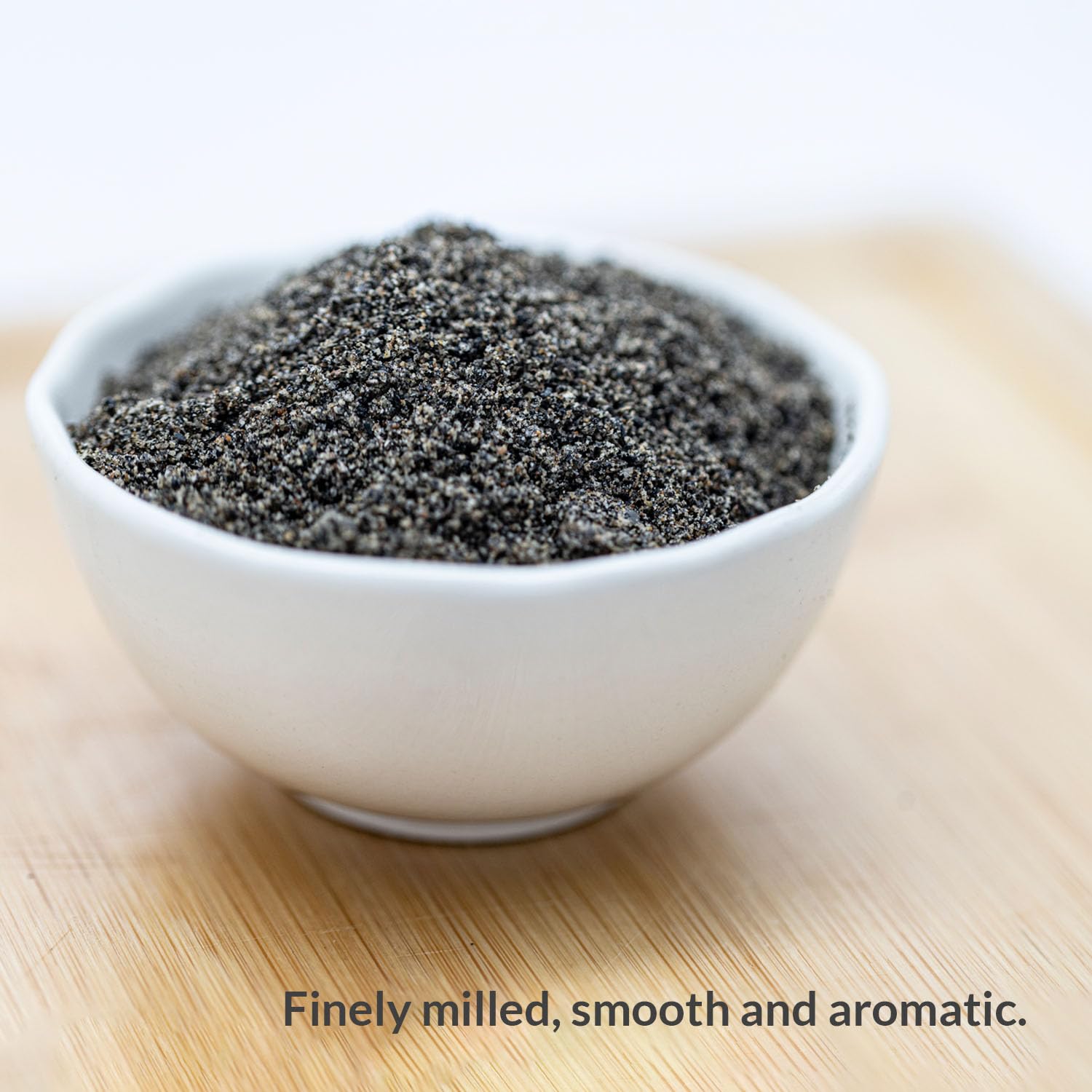 GREENMAX Black Sesame Powder dissolved in hot water forms a smooth, nutty beverage.