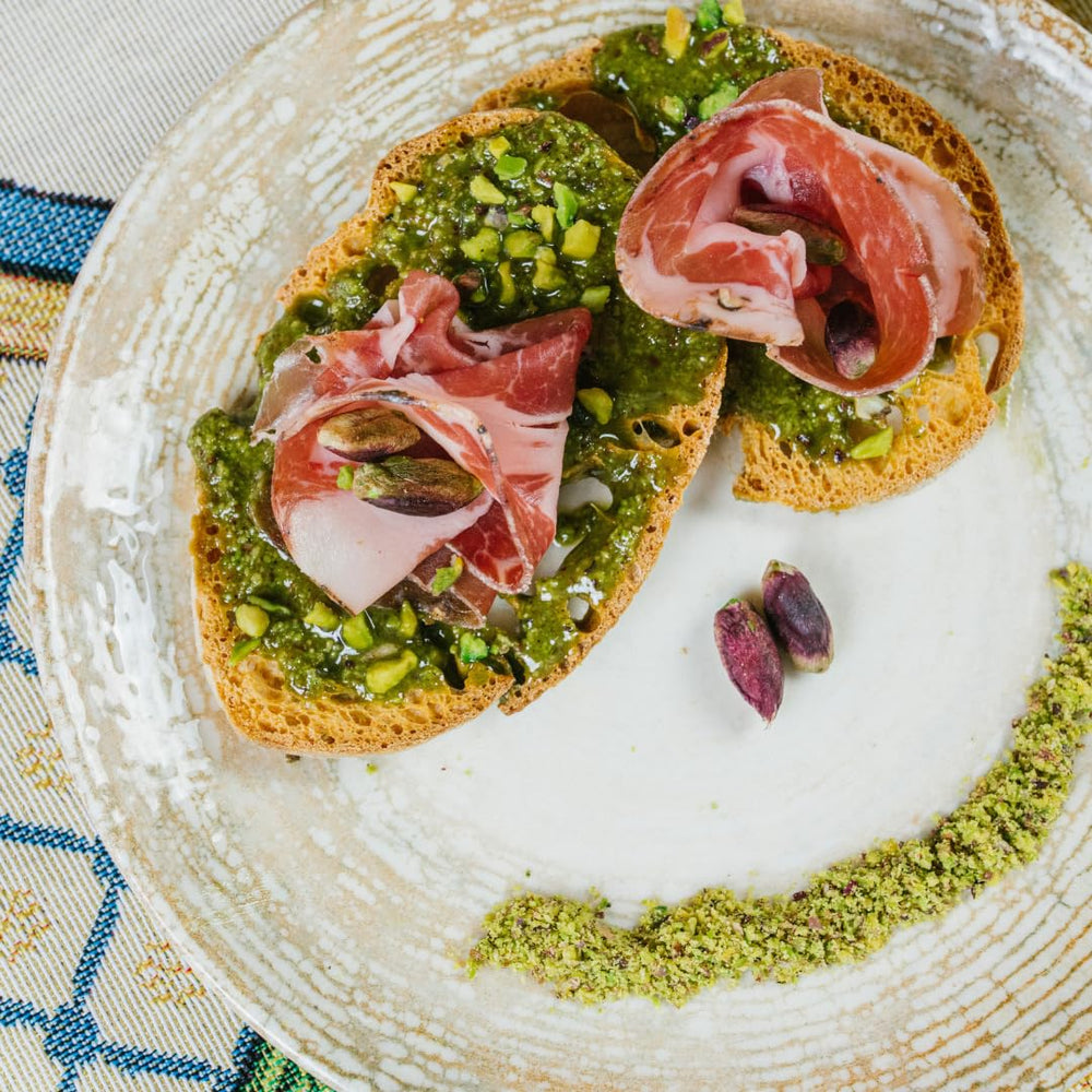 GUSTO ETNA Pistachio Pesto spread on crusty bruschetta for flavor