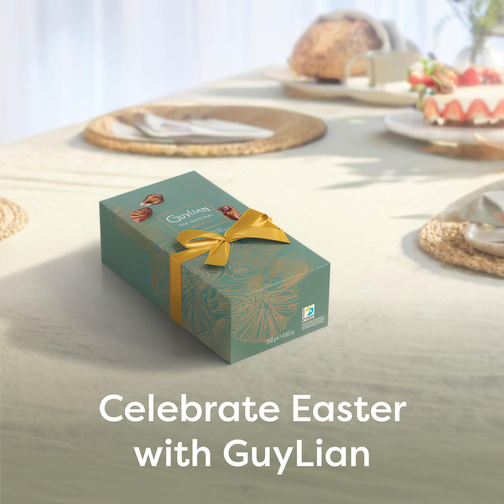 GuyLian hazelnut praline truffles with white and milk marbled shells, premium indulgence.