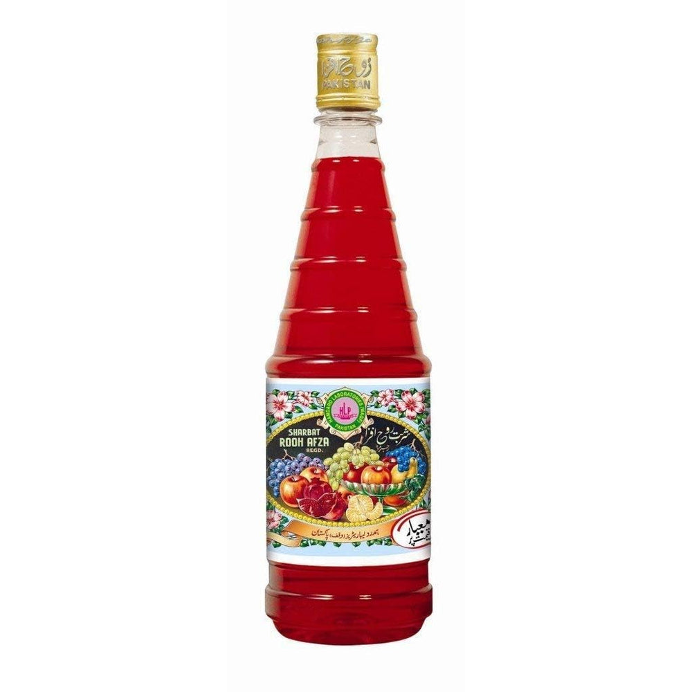 Hamdard Rooh Afza rose syrup being poured into a glass.
