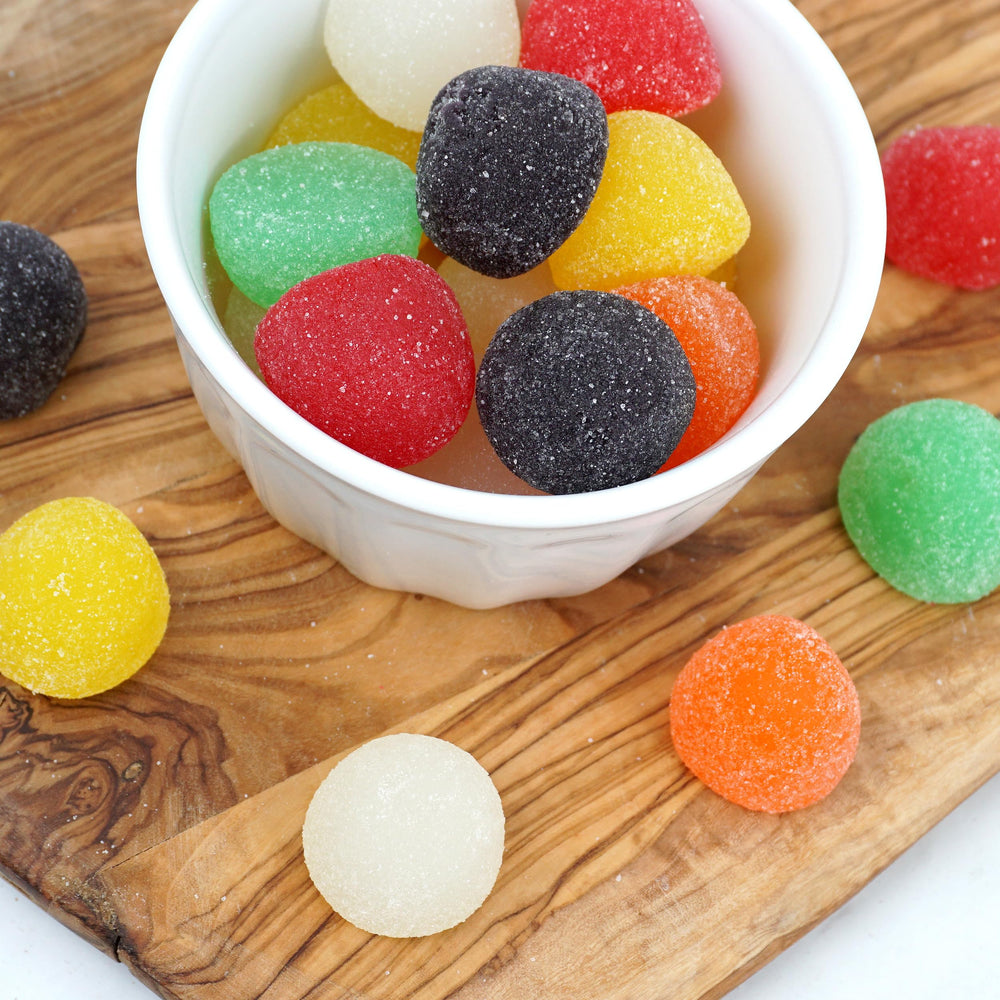 Gum drops arranged on a party table with assorted flavors.