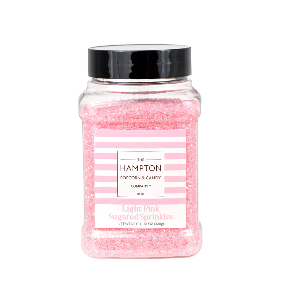 The Hampton Candy Company pink sanding sugar decorates cookies with whimsical, vibrant color.