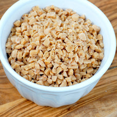 The Hampton Candy Company toffee bits ice cream topping in action with a scoop.