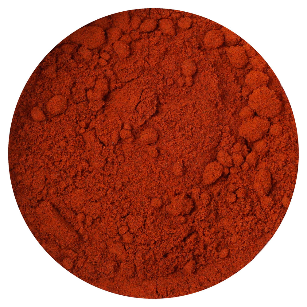 Hampton Distribution annatto powder jar close-up highlighting earthy, mild flavor for cooking.