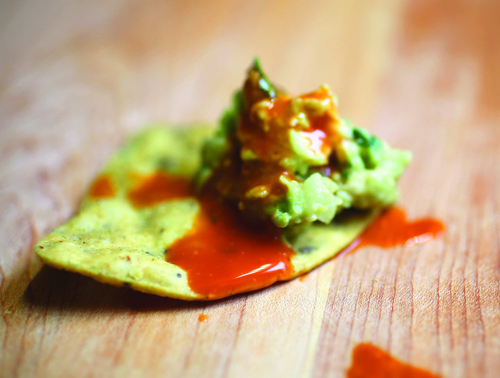 Hank's Heat hot sauce bottle pour demonstrates easy, controlled heat for wings.