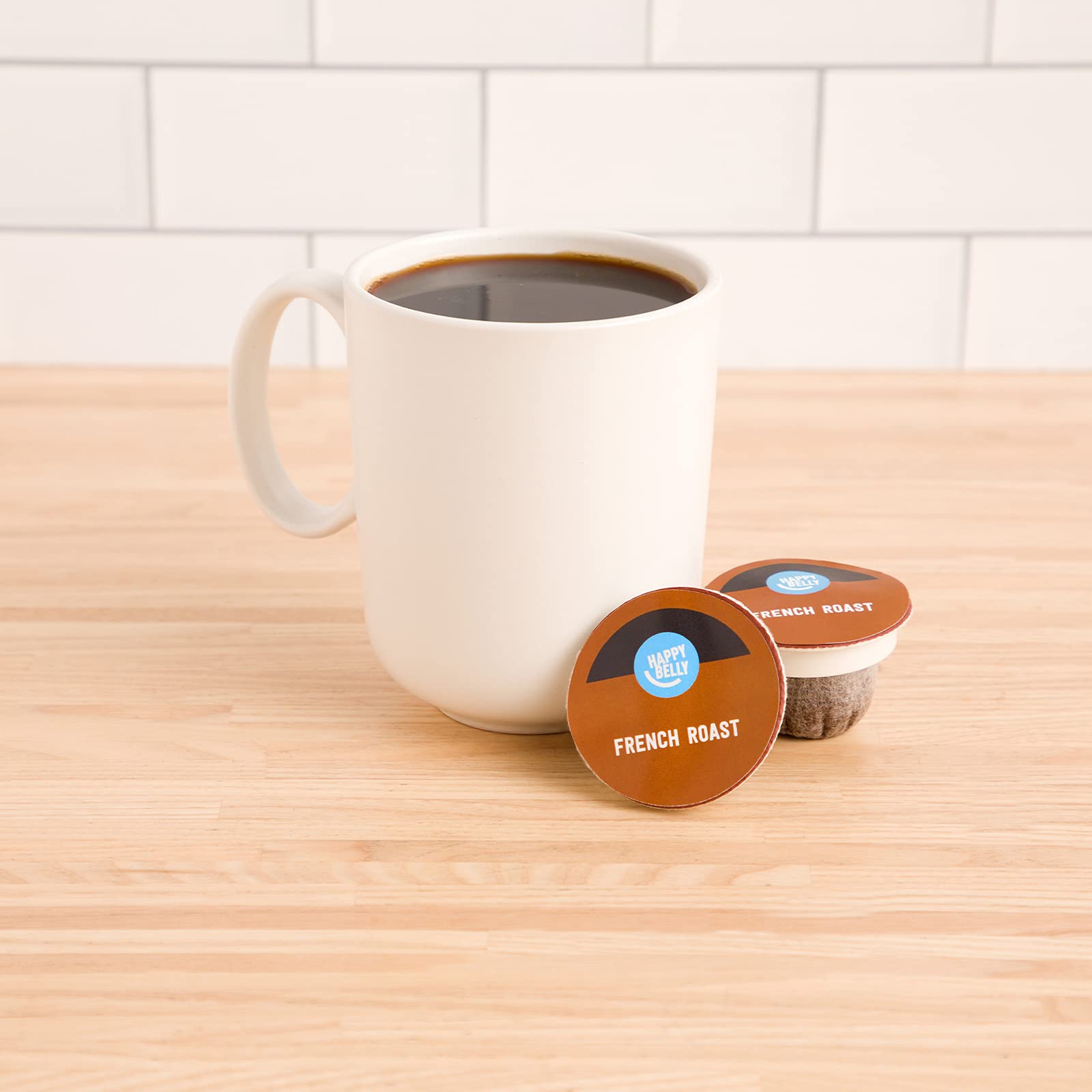 Happy Belly French Roast pods beside a K-Cup brewer confirming compatibility