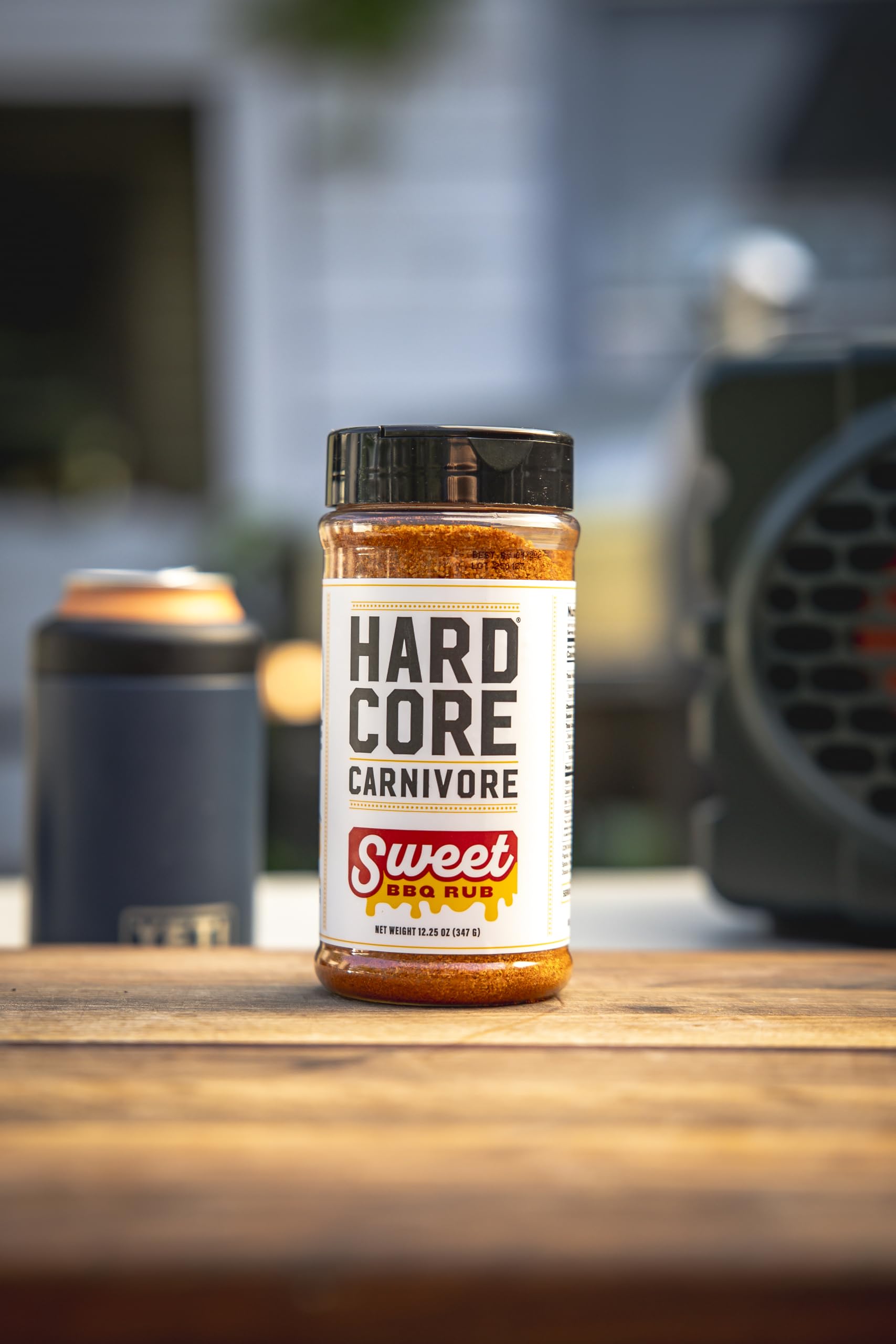 Hardcore Carnivore Sweet BBQ Seasoning on a smoky grill with bold aroma