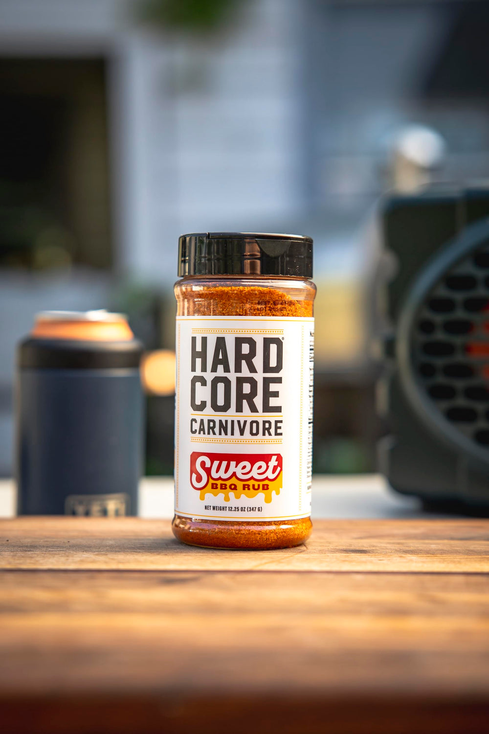 Hardcore Carnivore Sweet BBQ Seasoning on a smoky grill with bold aroma