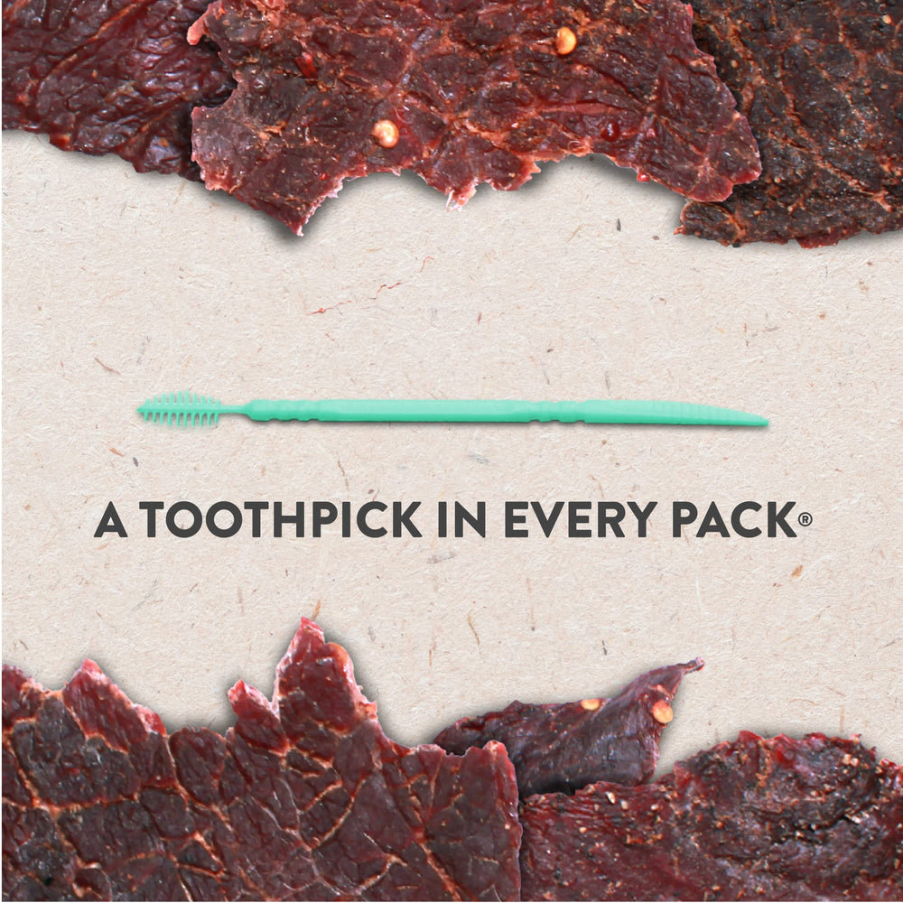 Hardtimes Hot Beef Jerky 4-pack in hand, ideal for grab-and-go fuel.