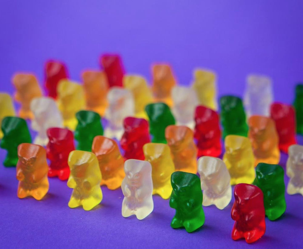 HARIBO Goldbears orange flavor icon with bright orange gummies.