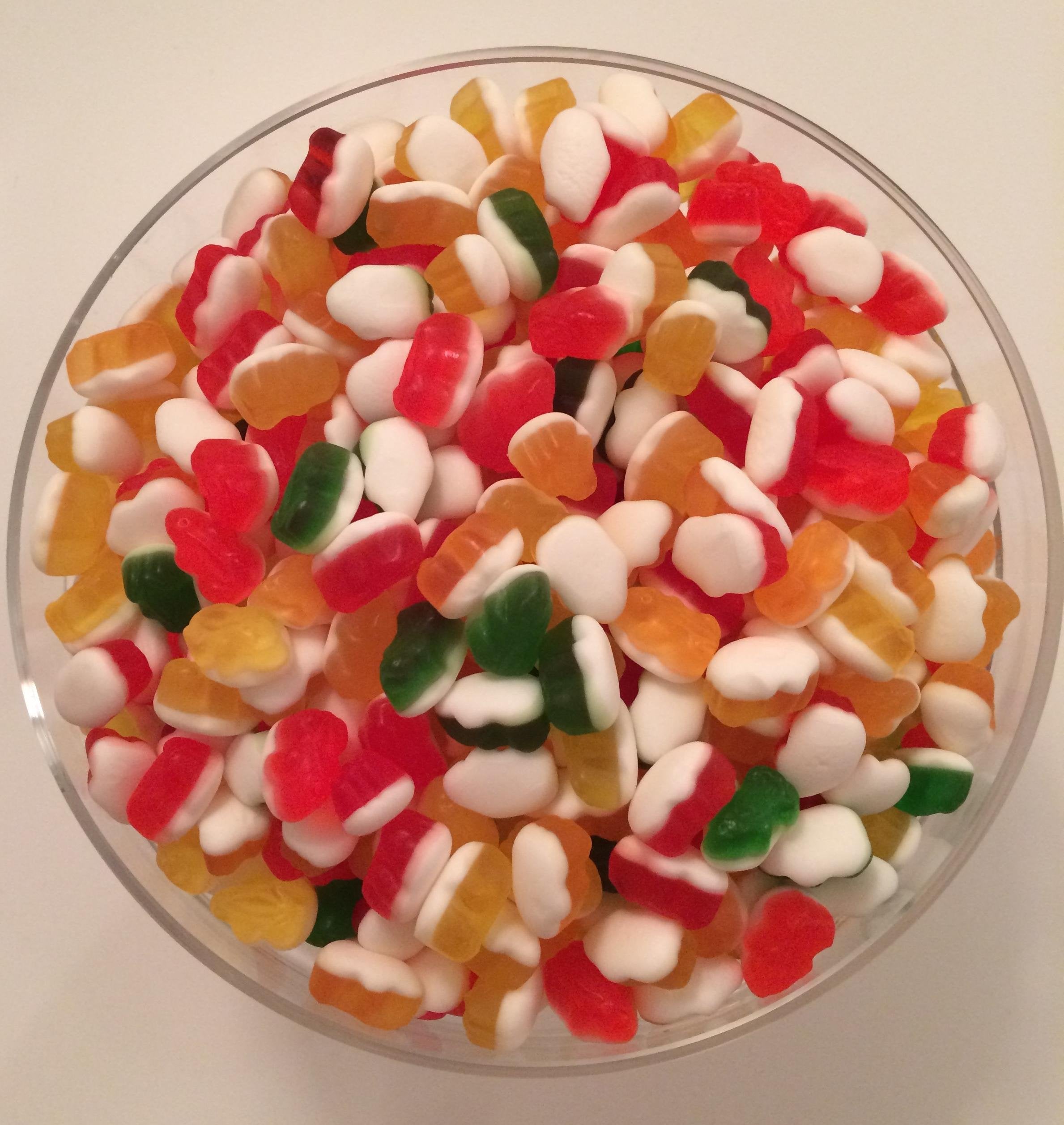 Children enjoying HARIBO Rainbow Frogs, a playful gummy treat.