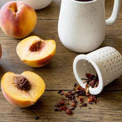 Harney & Sons Peach Fruit Tea orange-peel and fruit mix, colorful caffeine-free tea visuals.