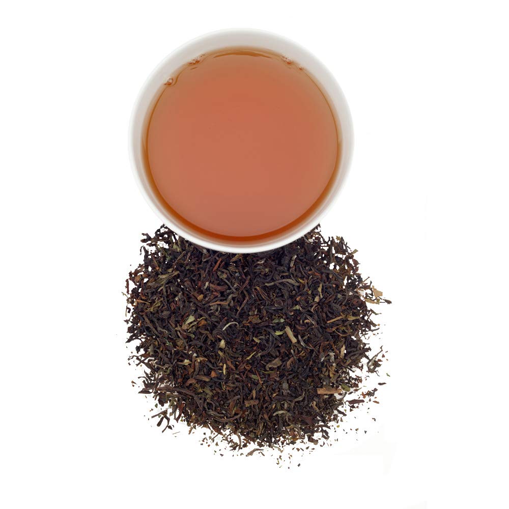 Garden setting with Harney & Sons Darjeeling black tea leaves on display.