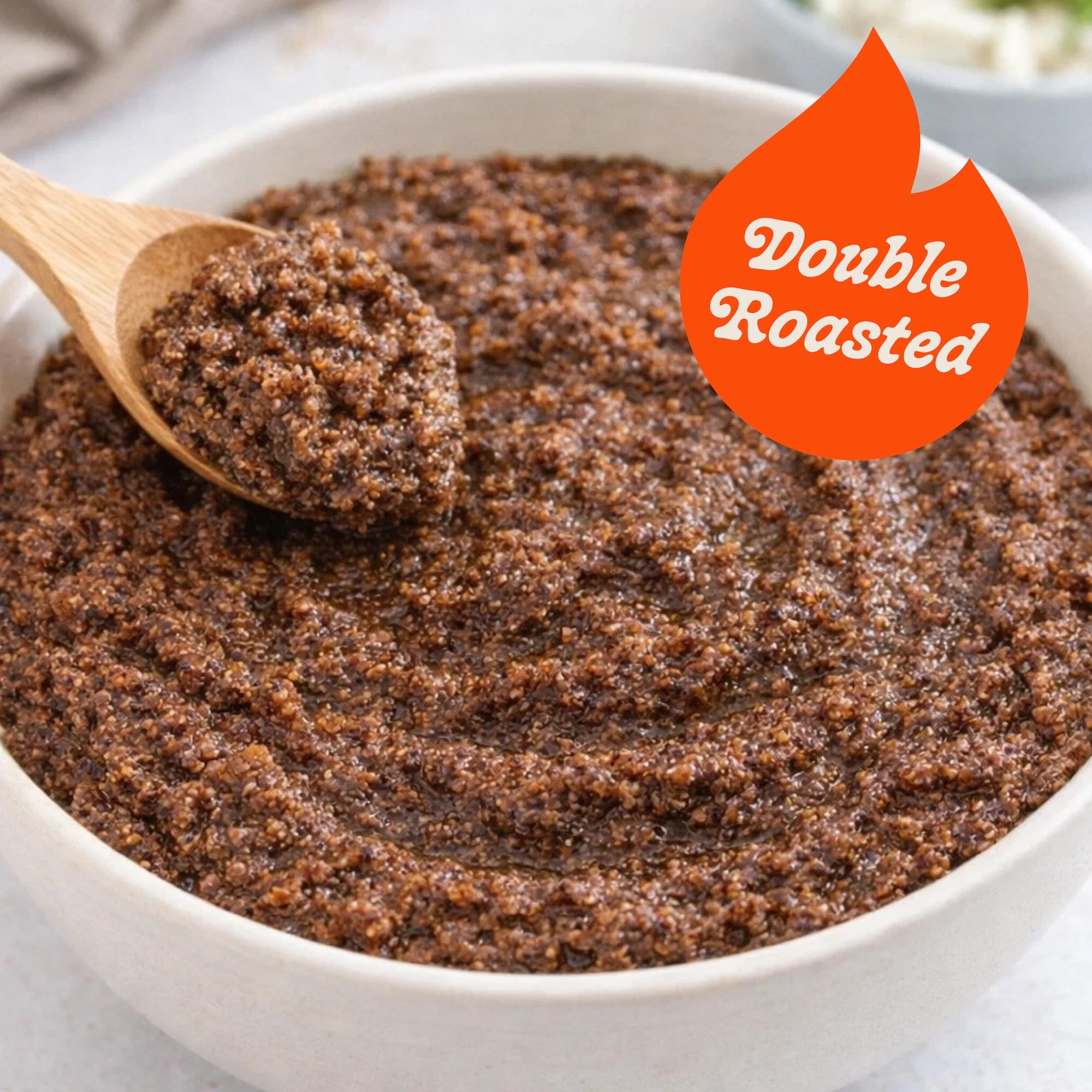 Hasho single-ingredient poppy seed paste spoon closeup emphasizes pure, unsweetened quality.