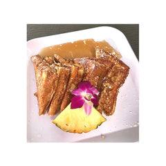 Plate of Hawaii's Best coconut French toast with fresh fruit.
