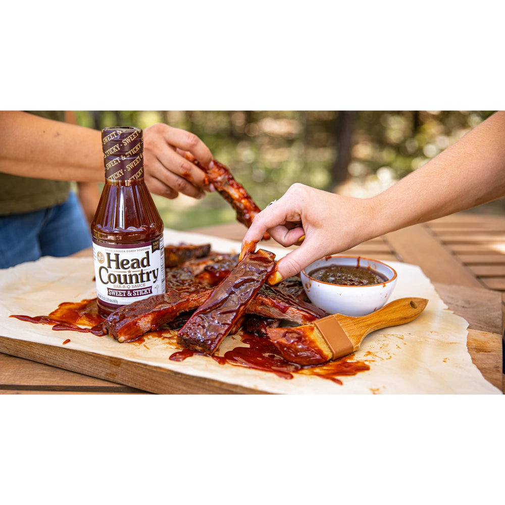 Head Country Sweet & Sticky sauce on grill for finishing touches.