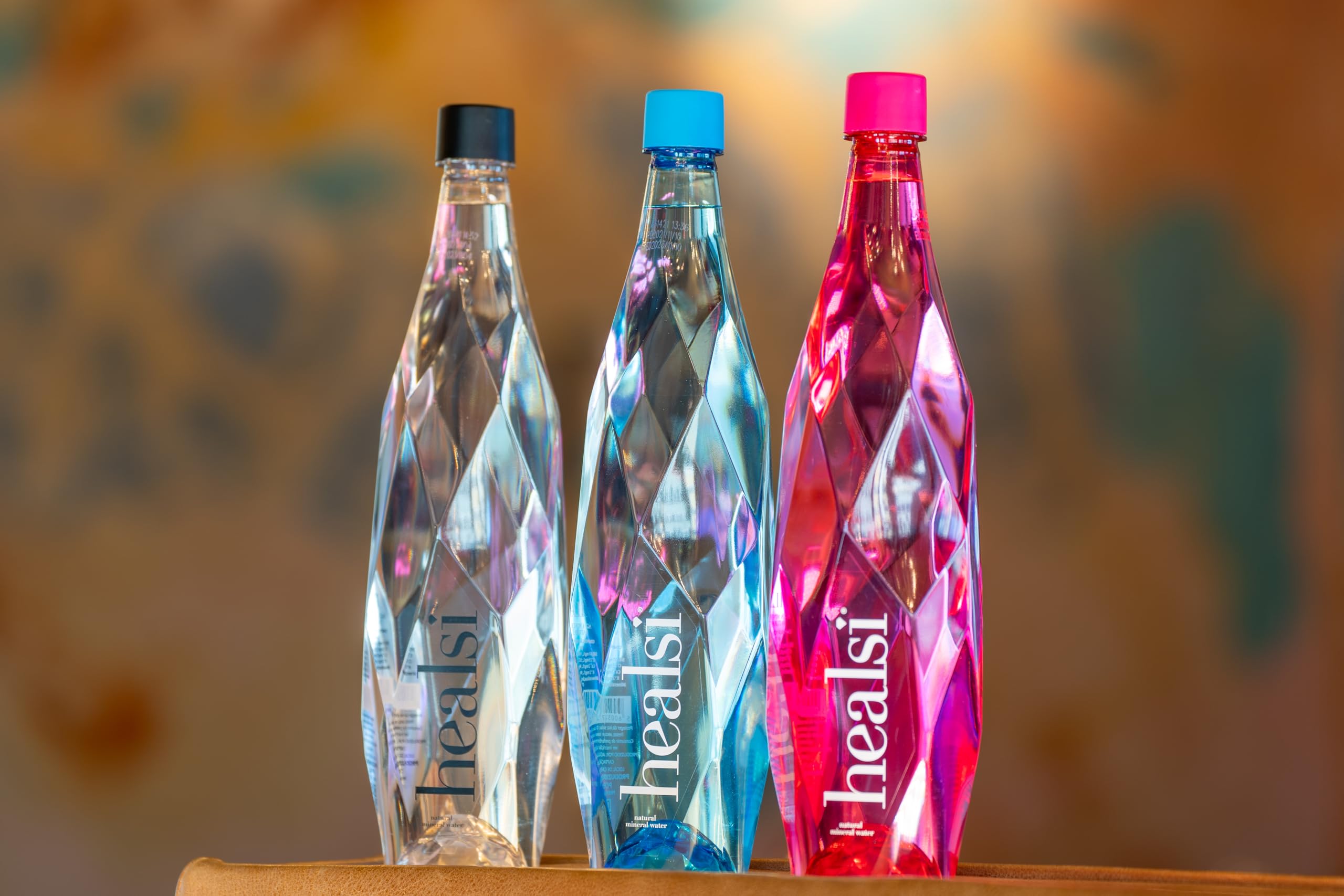 Healsi six-bottle pack on table for travel-friendly hydration.