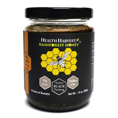 Health Harvest Tualang Honey jar close-up, raw and unfiltered, rich amber color.