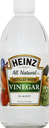 Pour shot of Heinz white vinegar ideal for brightening marinades and sauces.