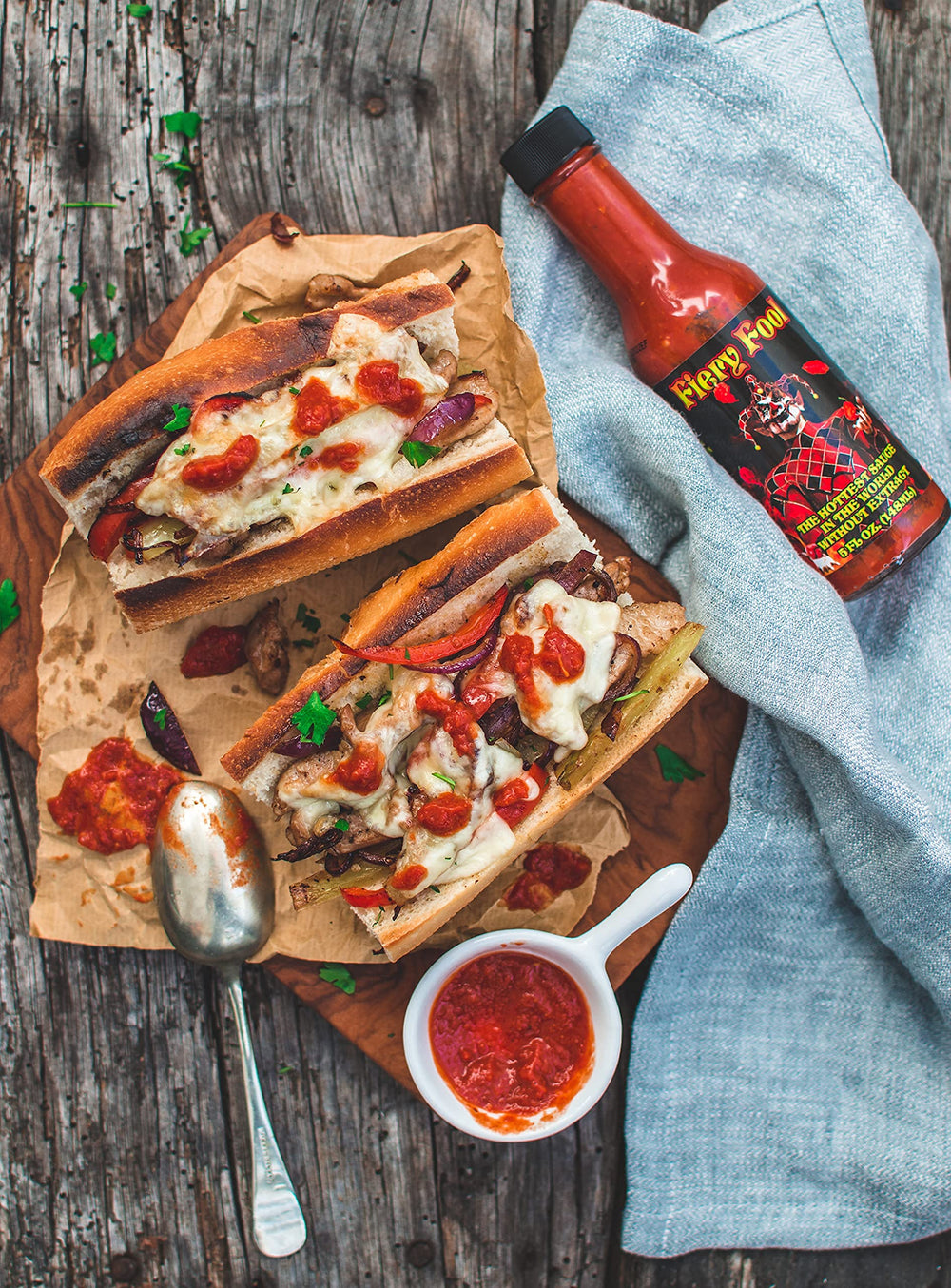 Dipping wings in Fiery Fool illustrates spicy flavor boost.