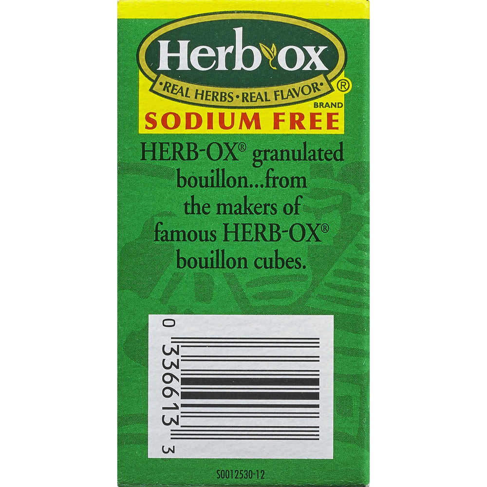 Spoon dispersing Herb-Ox granules into water for instant seasoning.
