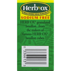 Spoon dispersing Herb-Ox granules into water for instant seasoning.