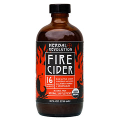 Herbal Revolution Fire Cider bottle on wood for spicy flavor in recipes
