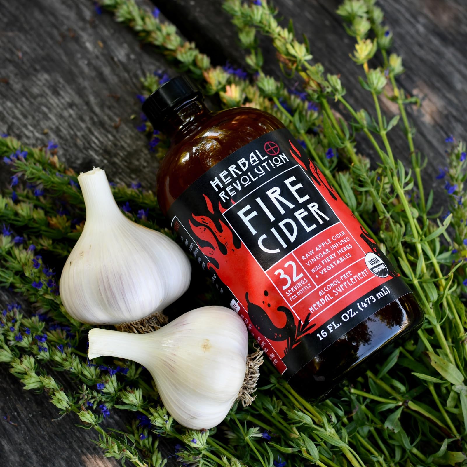 Herbal Revolution Fire Cider ingredient jar showcases burdock root and dandelion root.