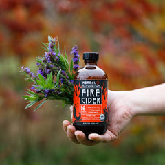 Pouring Herbal Revolution Fire Cider for a warming beverage or marinade