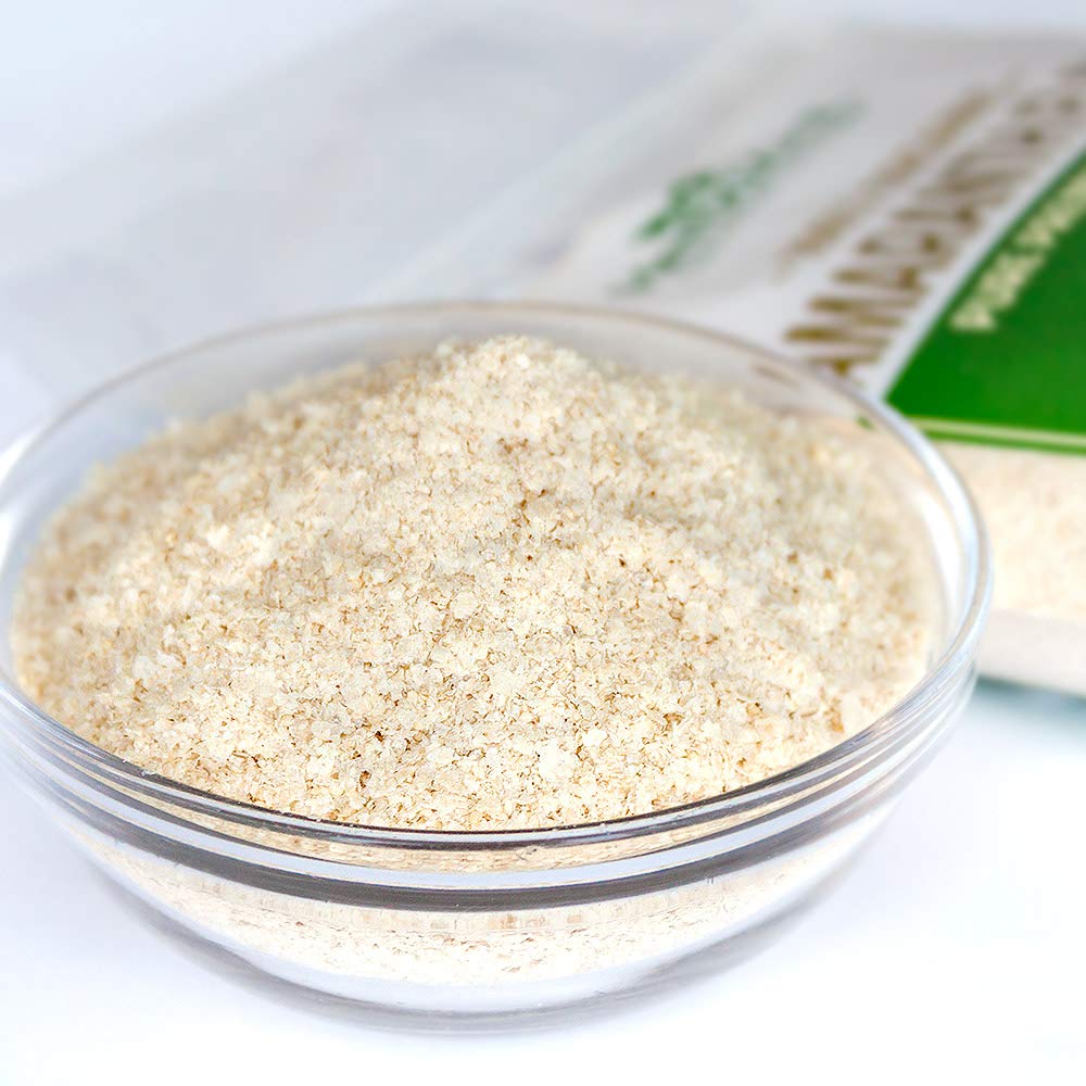 Pouring HerbaZest Amaranth Flakes into a smoothie for added protein and fiber.