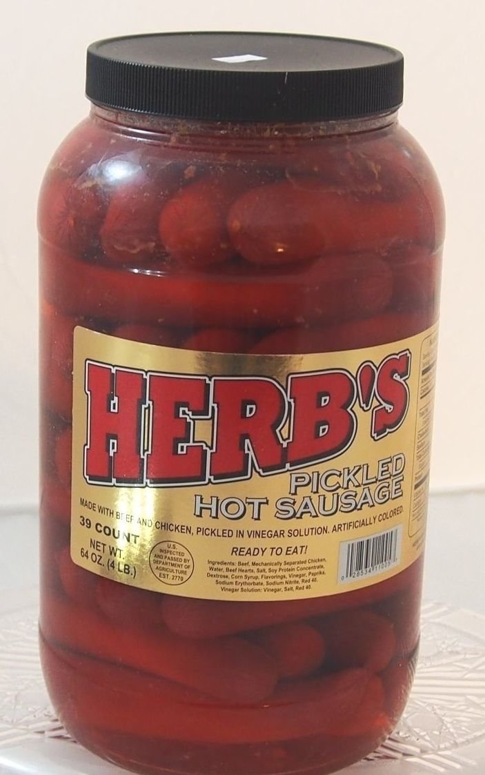 Herbs red hot pickled sausage jar front view, ready-to-eat snack for gatherings.