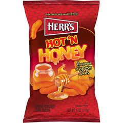 Seasoning specks on Herr's Hot & Honey Cheese Curls highlight bold taste.