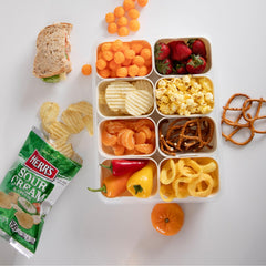 Herr's Sour Cream and Onion bag displayed on table for easy snack access