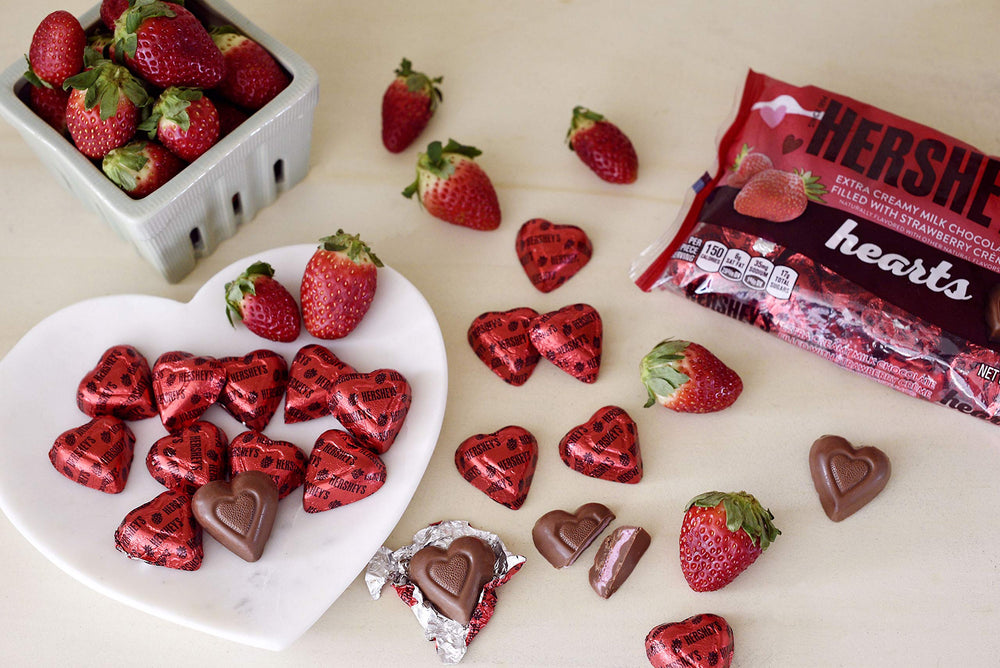 HERSHEY'S extra creamy milk chocolate hearts arranged for a party candy table.