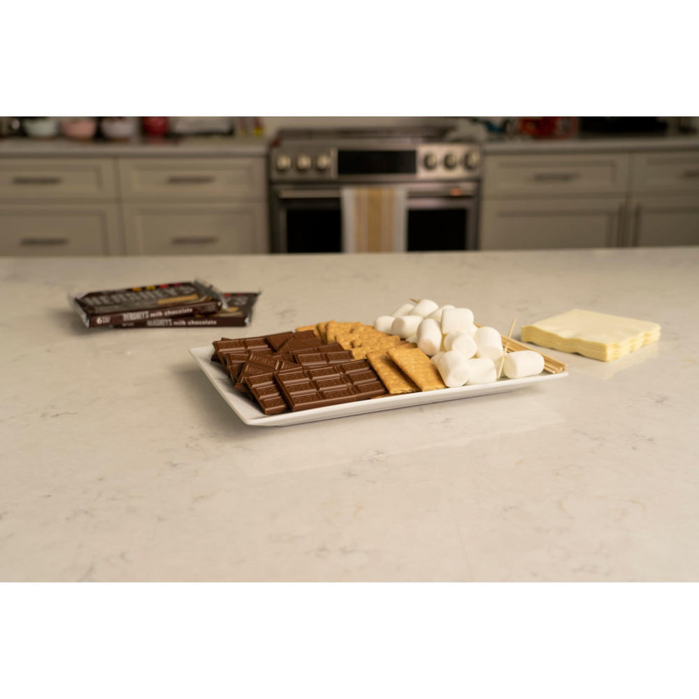 HERSHEY'S S'mores Kit Box camping scene evokes shared memories around a fire.