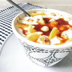 Hey Boo coconut caramel sauce draped over a scoop of ice cream