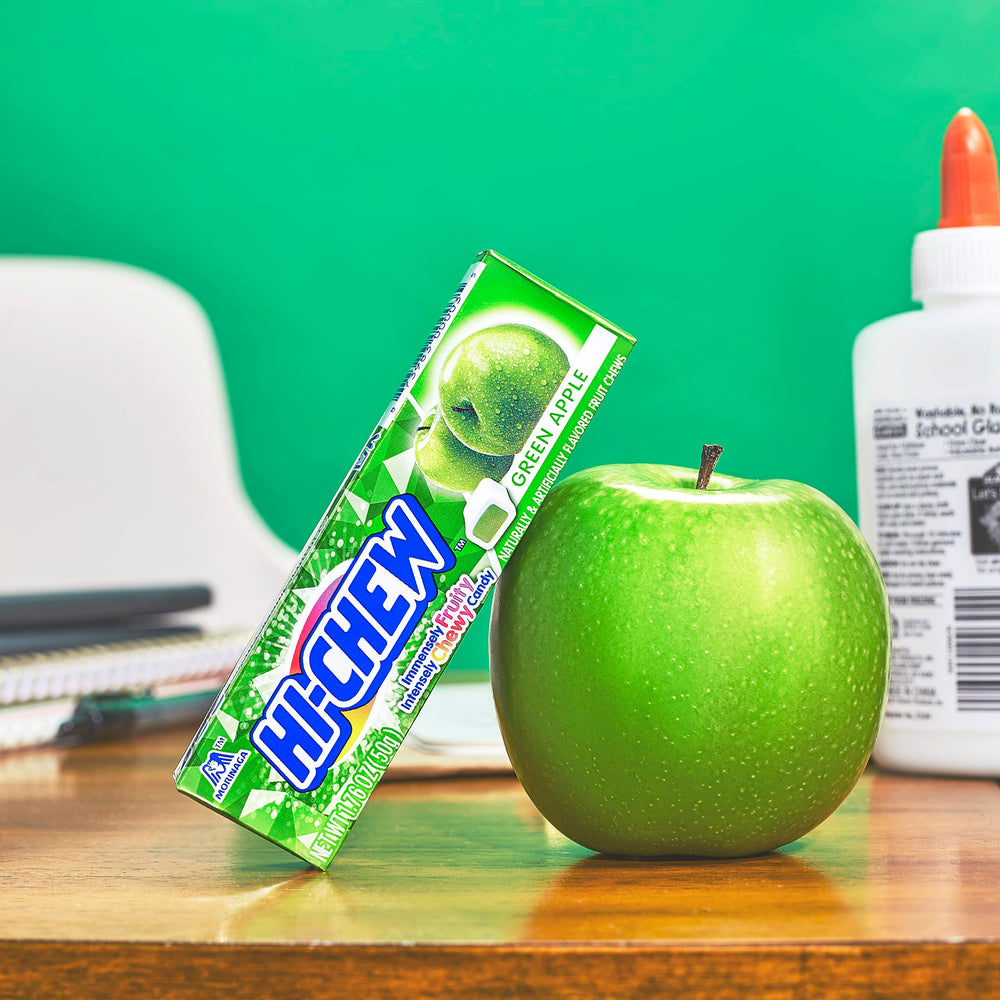 HI-CHEW Green Apple Sticks on desk, perfect quick treat between tasks.