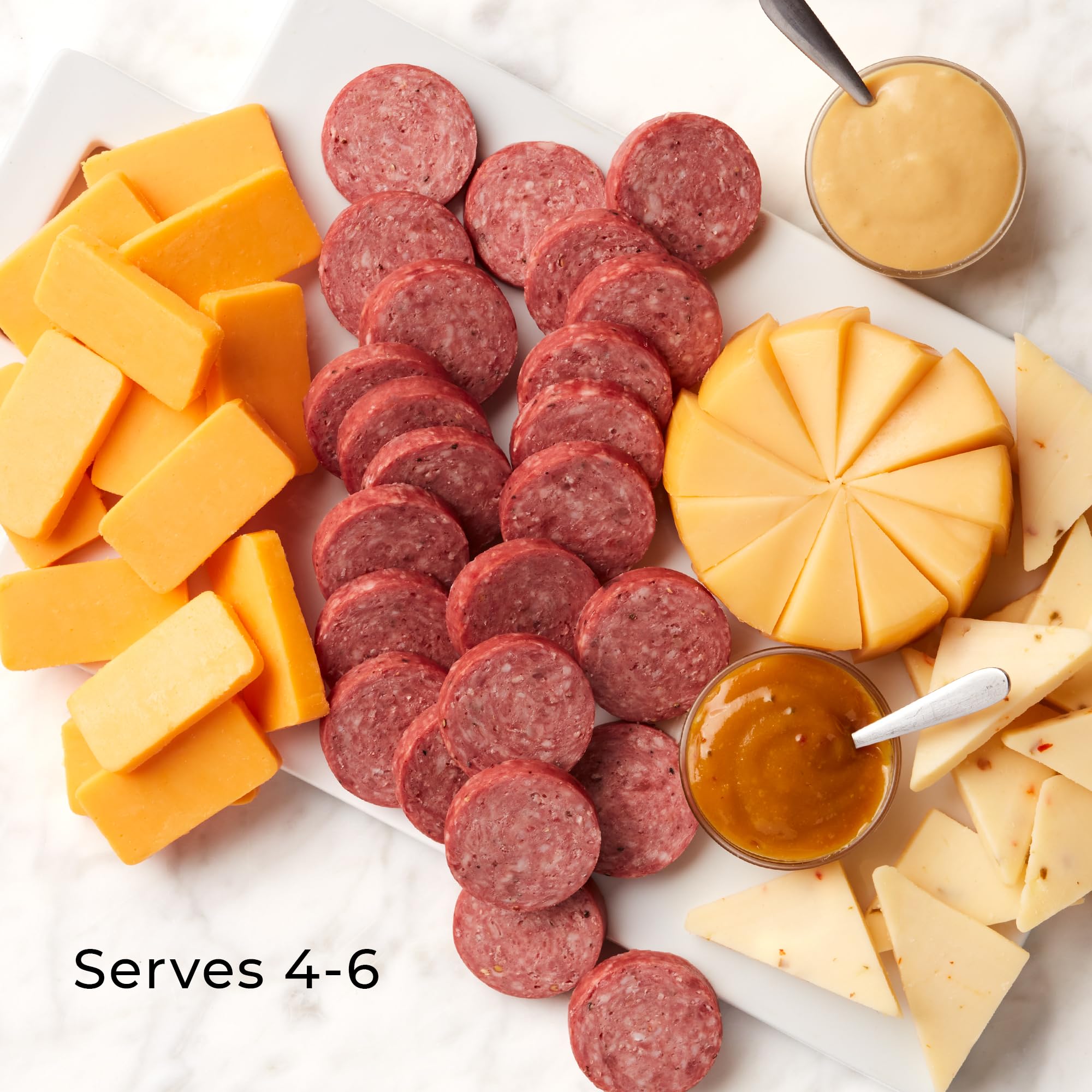 Hickory Farms Honey Pineapple Mustard beside cheeses, a sweet glaze for dipping and pairing.